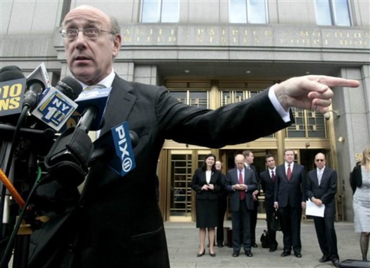 While other attorneys wait their turn at media microphones, Kenneth Feinberg, left, former special master for the September 11th Victim Compensation Fund, speaks during a news conference outside U.S. Federal District Court, on Thursday.
